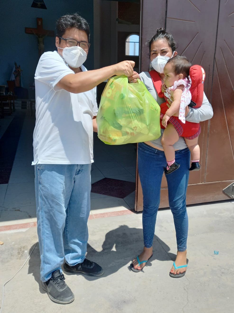 Father César Anicama ministers to people during their pain and suffering in the Peruvian coastal city of Villa El Salvador while serving with the Missionary Society of St. James the Apostle during the COVID-19 pandemic. Here, he is seen delivering bags of food to people who are hungry.